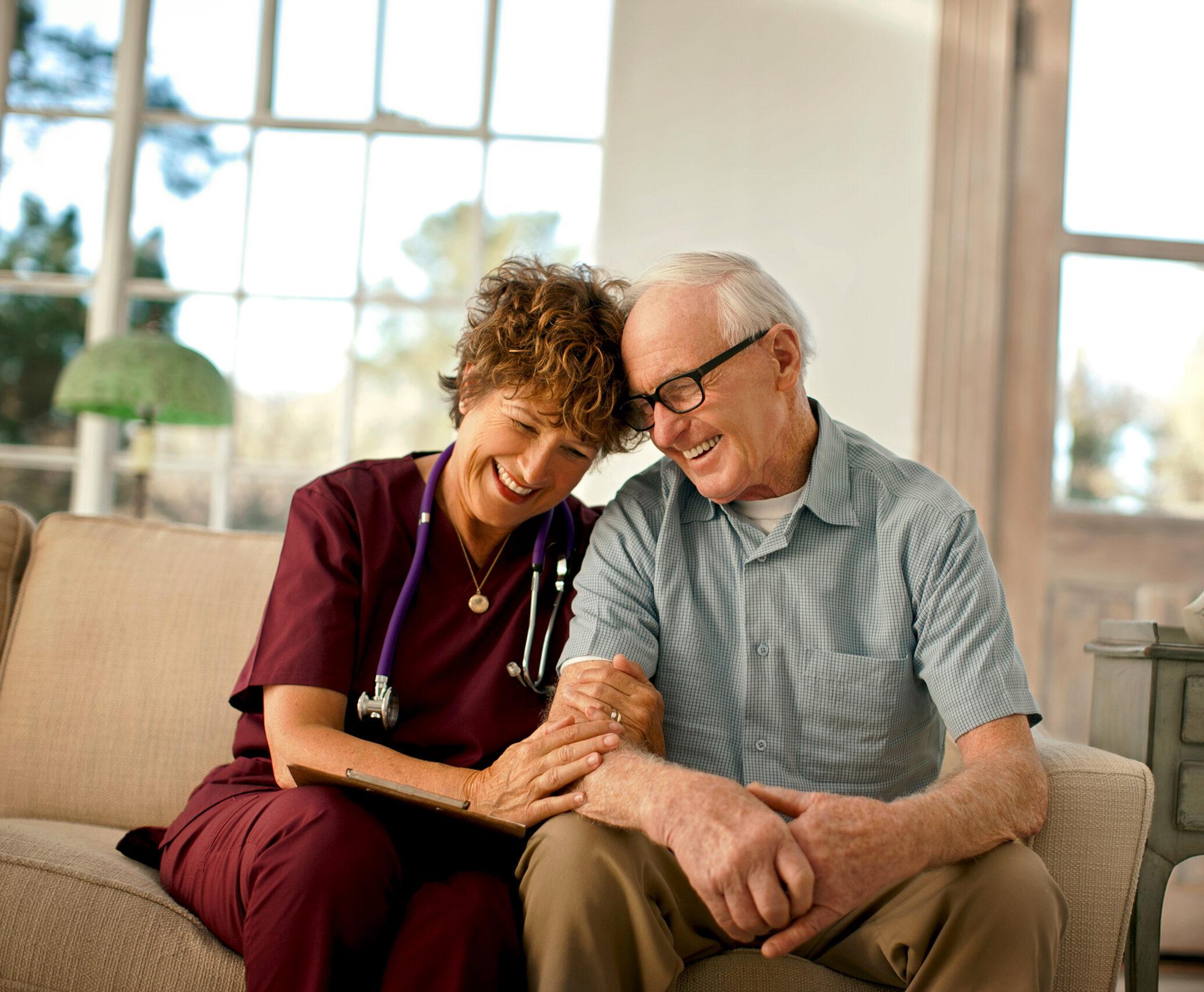 A compassionate home care nurse comforts a patient.