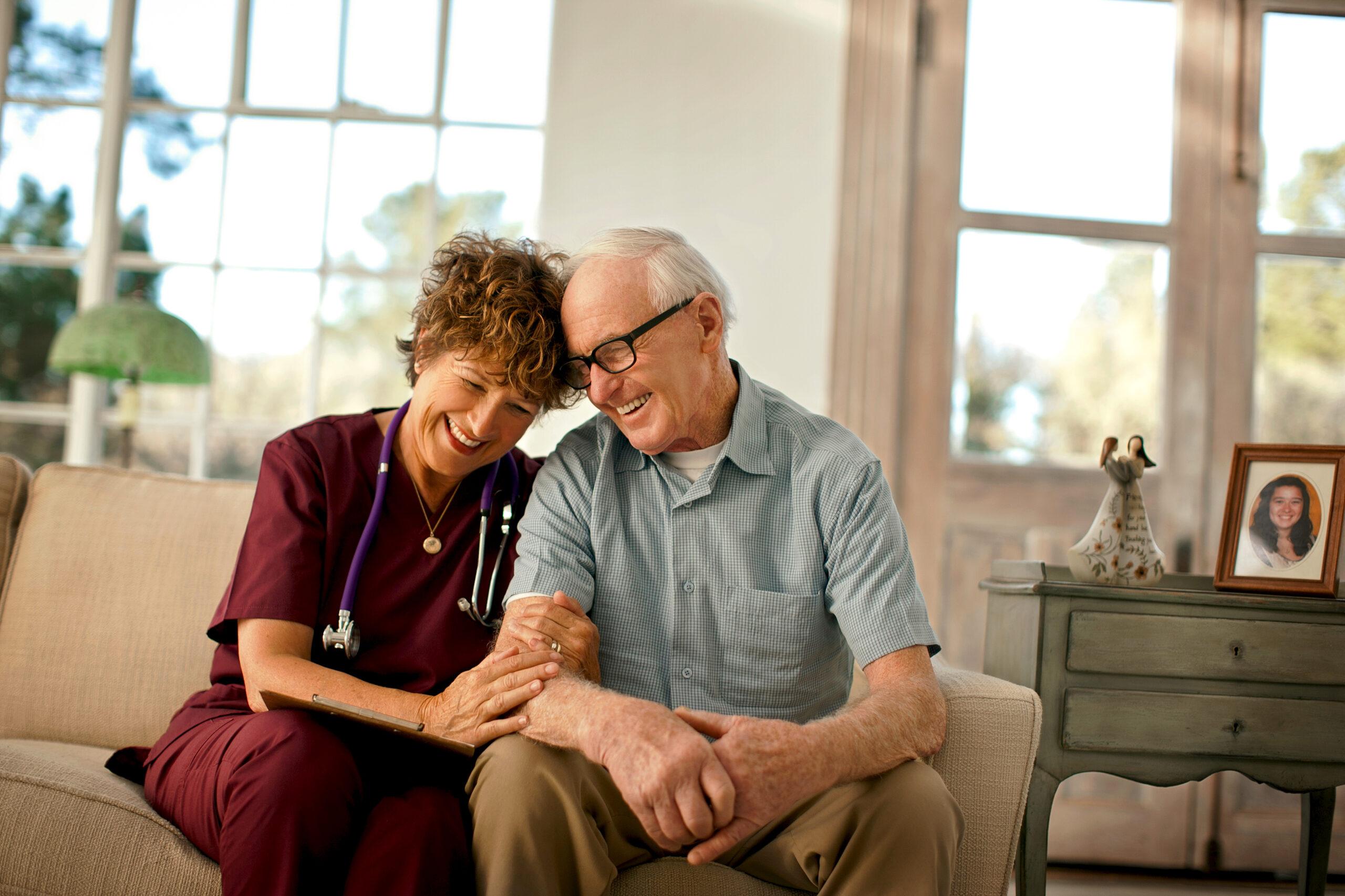A compassionate home care nurse comforts a patient.